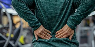 Women holding lower back from pain
