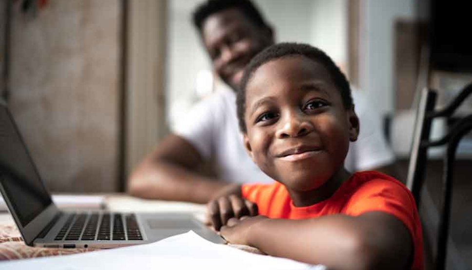 Child on laptop with father